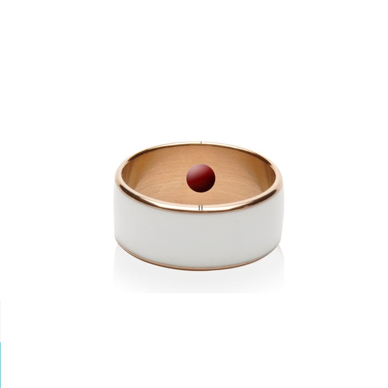 Ring with gold band and white stone on a white background
