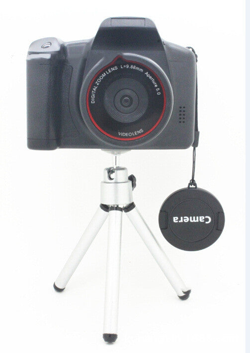 Toy camera with lens and tripod on a white background