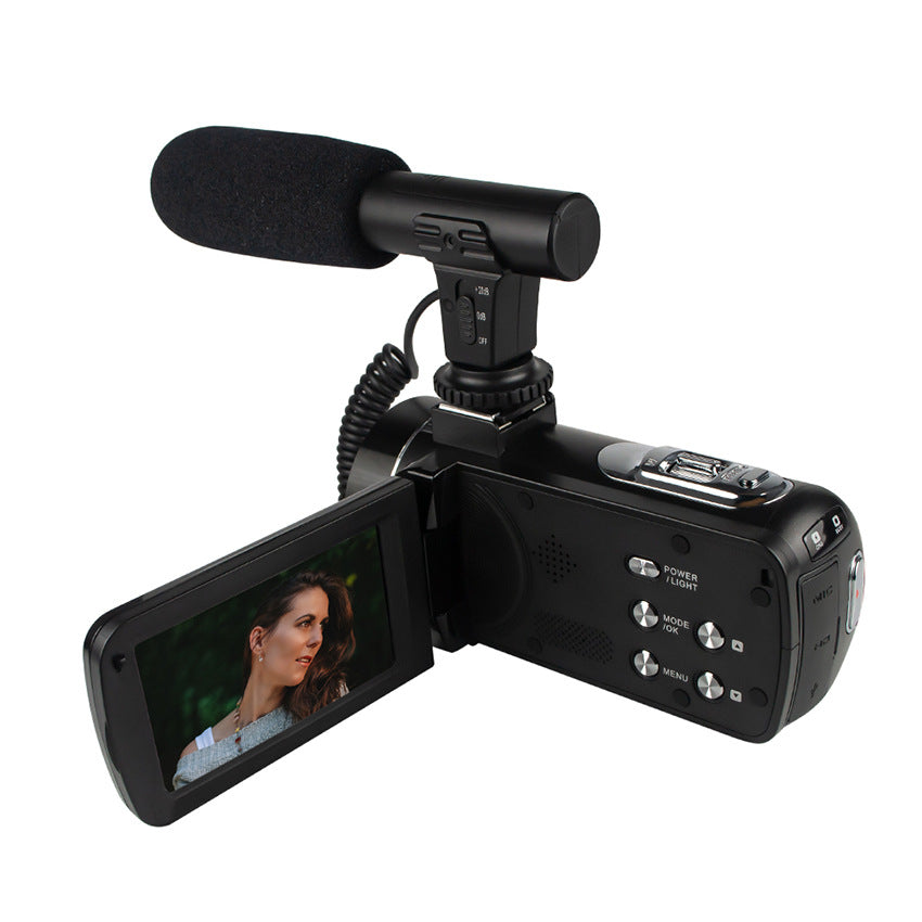 Black video camera with microphone on a white background
