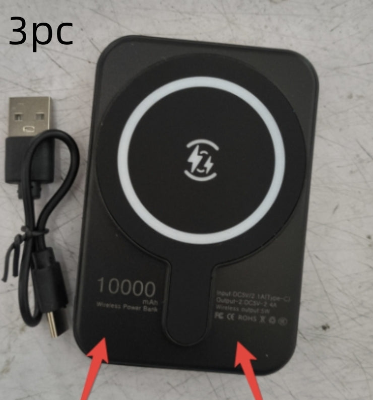 Black wireless power bank with USB cable on a textured surface