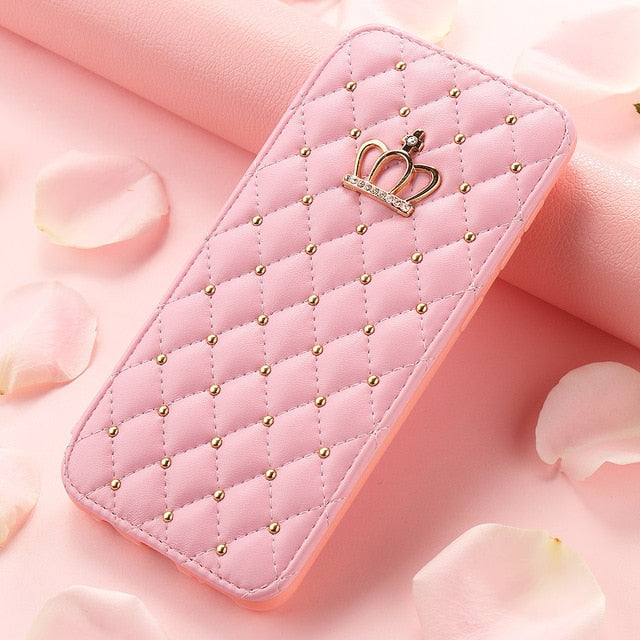 Pink quilted phone case with gold studs and a crown emblem on a soft pink background.