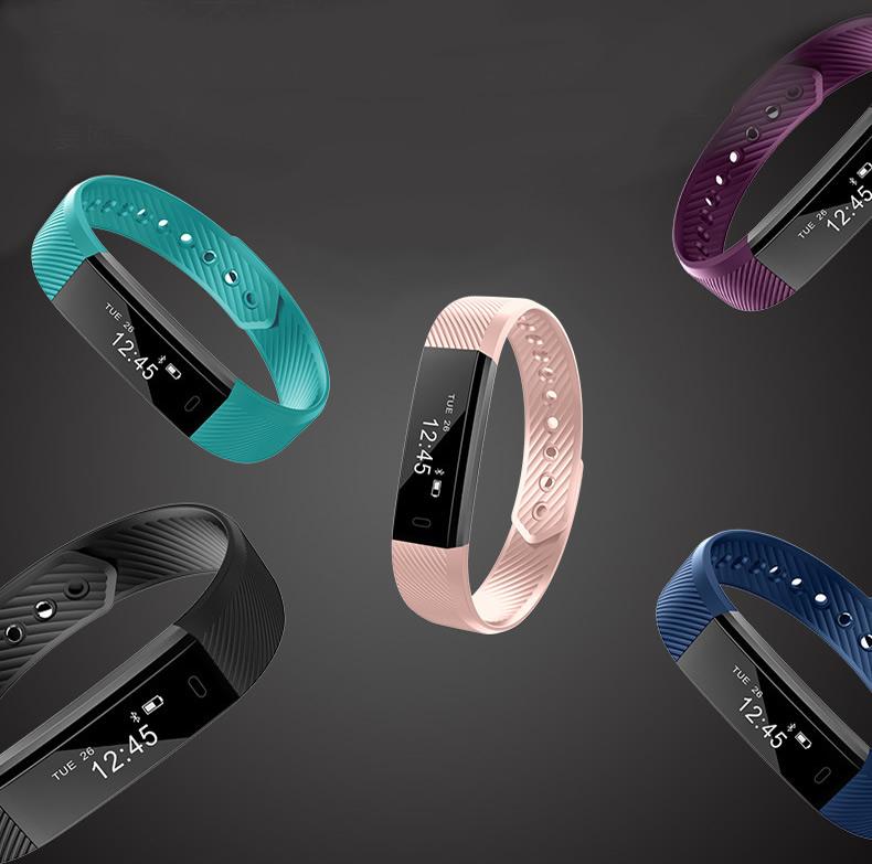 Five colorful fitness trackers on a dark background