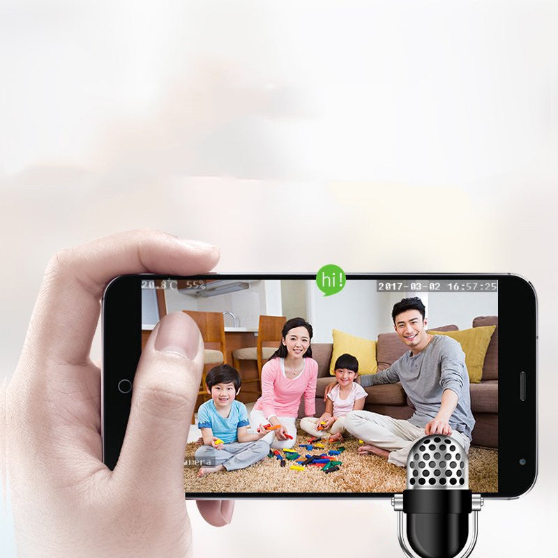 Smartphone with a video call app showing a family on a screen, held by a hand.