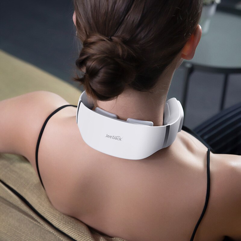 Person wearing a white neck massager with 'Jewelry' branding.