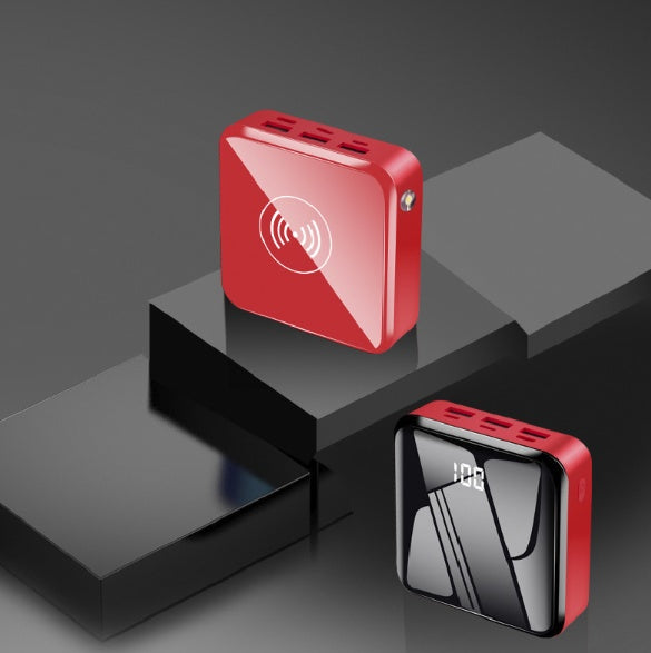 Red portable electronic device with wireless charging symbol on a dark background