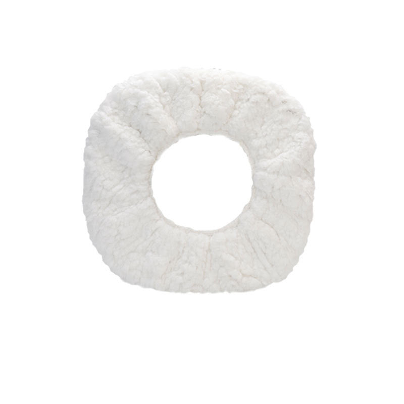 White textured donut-shaped object on a white background