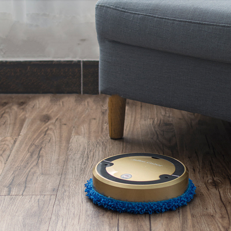 Robotic floor cleaner on a wooden floor next to a gray sofa.