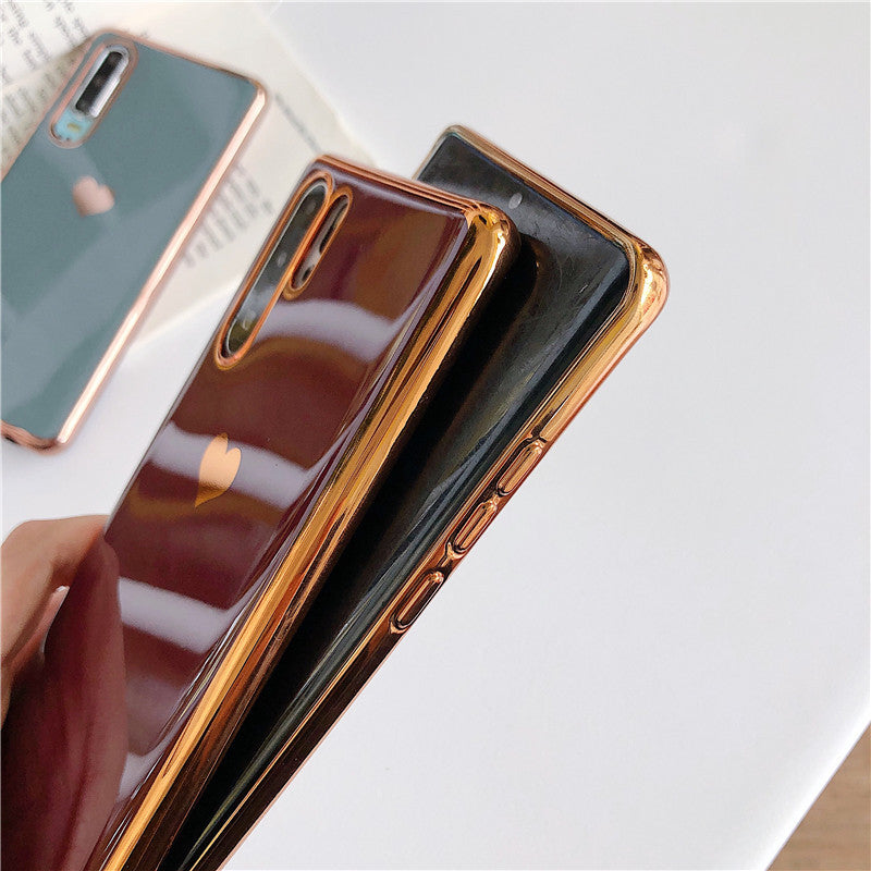 Phone case with rose gold trim on a white surface