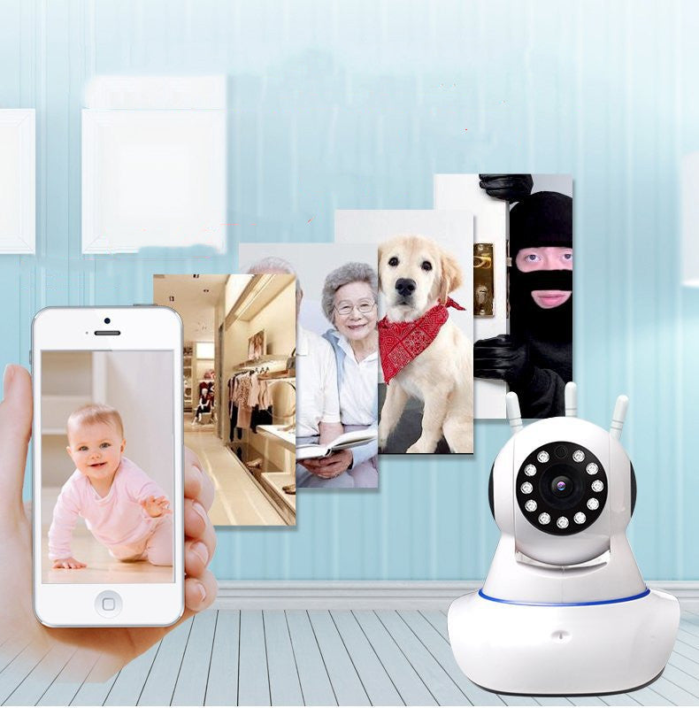 Smart home security camera with smartphone displaying baby monitor app, and various images on a wall.