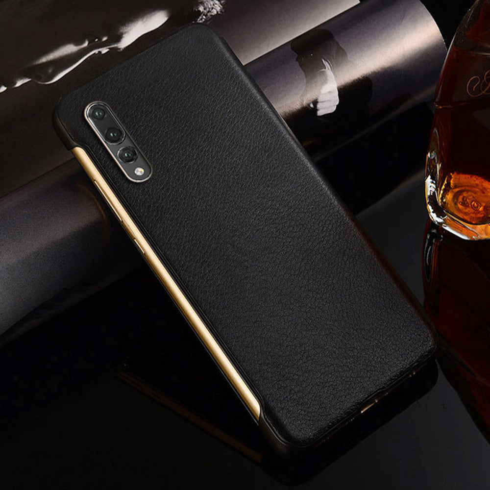 Black phone case on a reflective surface with a glass of whiskey in the background