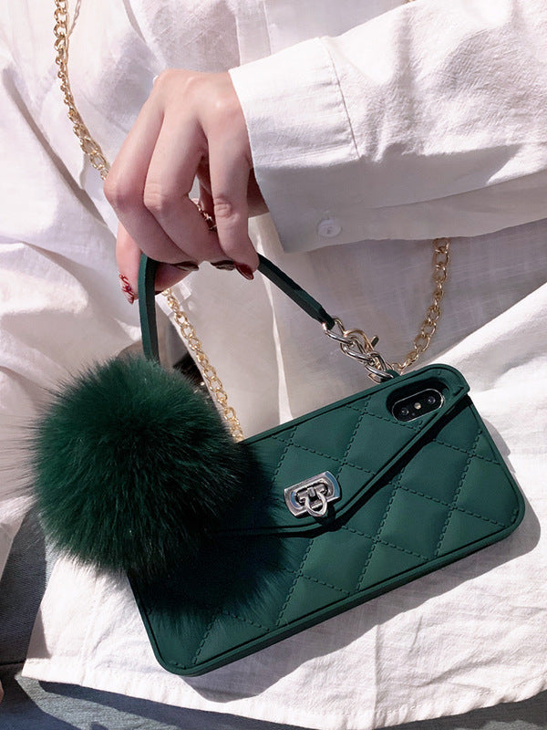 Green quilted phone case with a fluffy pom-pom on a white background