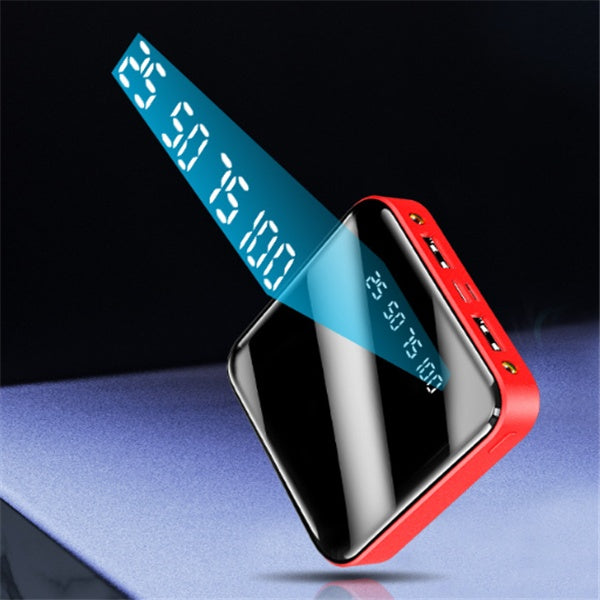Red power bank with digital display on a reflective surface