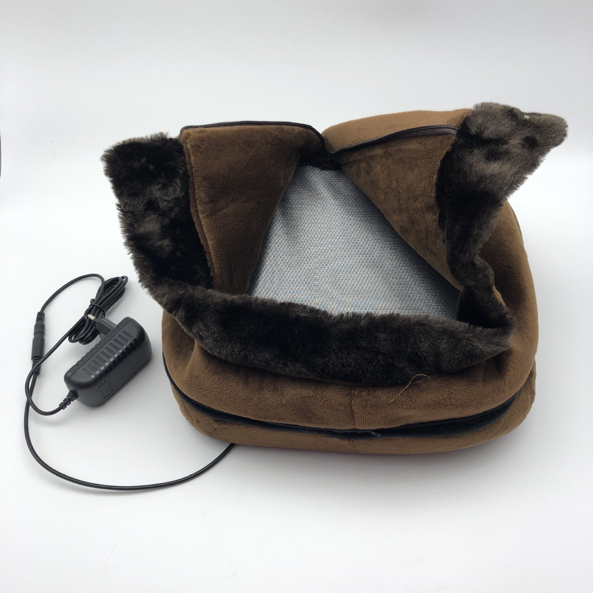 Brown heated neck pillow with fur trim and power adapter on a white background
