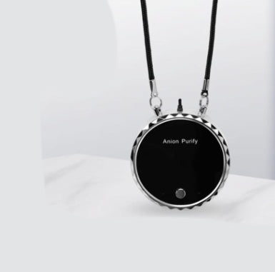 Black circular pendant necklace on a white background