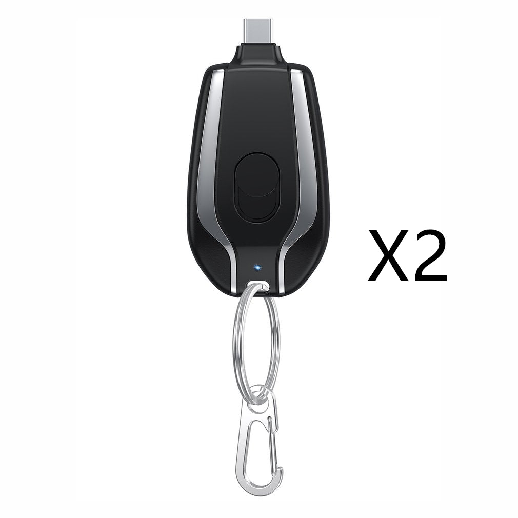 Black and silver remote control with carabiner on a white background