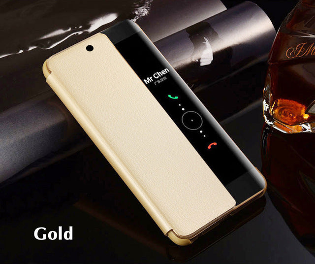 Gold phone case on a smartphone with a bottle of whiskey in the background