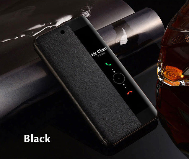 Black phone case on a dark surface with a glass of whiskey