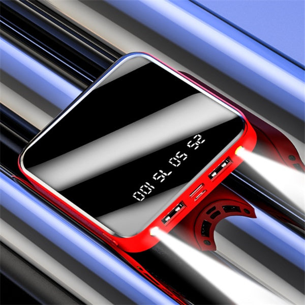 Red and black power bank with digital display on a reflective surface