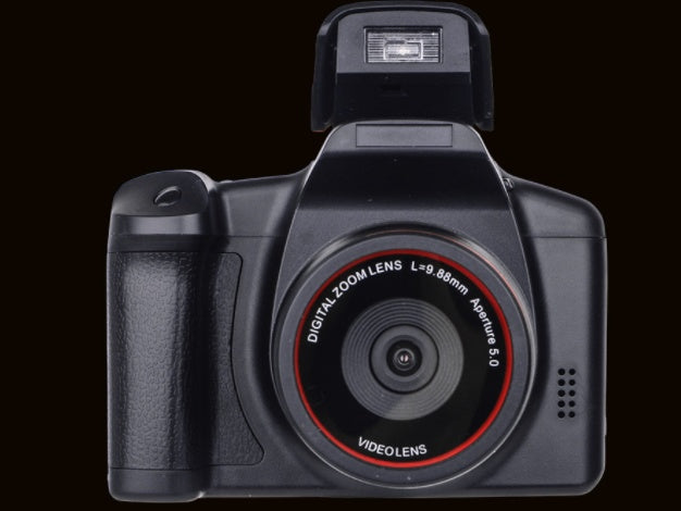 Digital camera with lens and flash on a black background