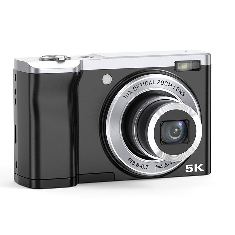 Black digital camera with silver accents on a white background