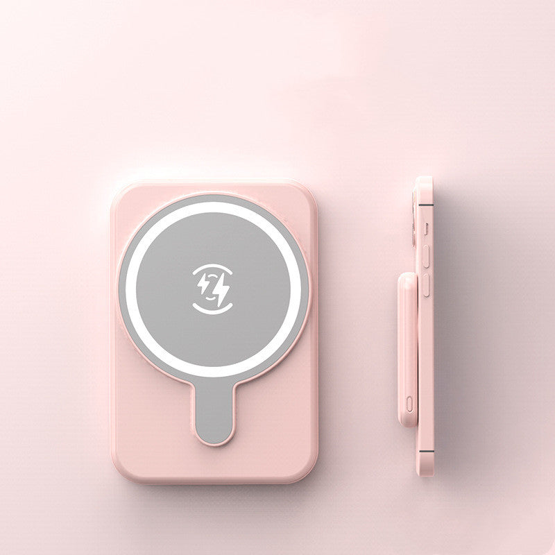 Pink wireless charging pad with a smartphone on a light pink background