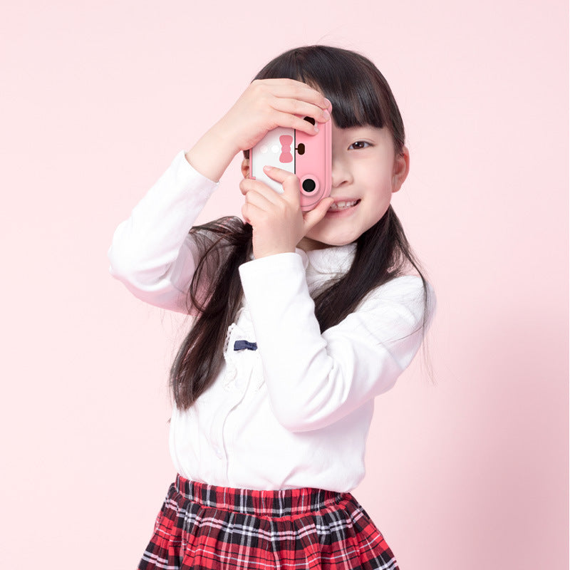 Young girl holding a pink phone case against a pink background