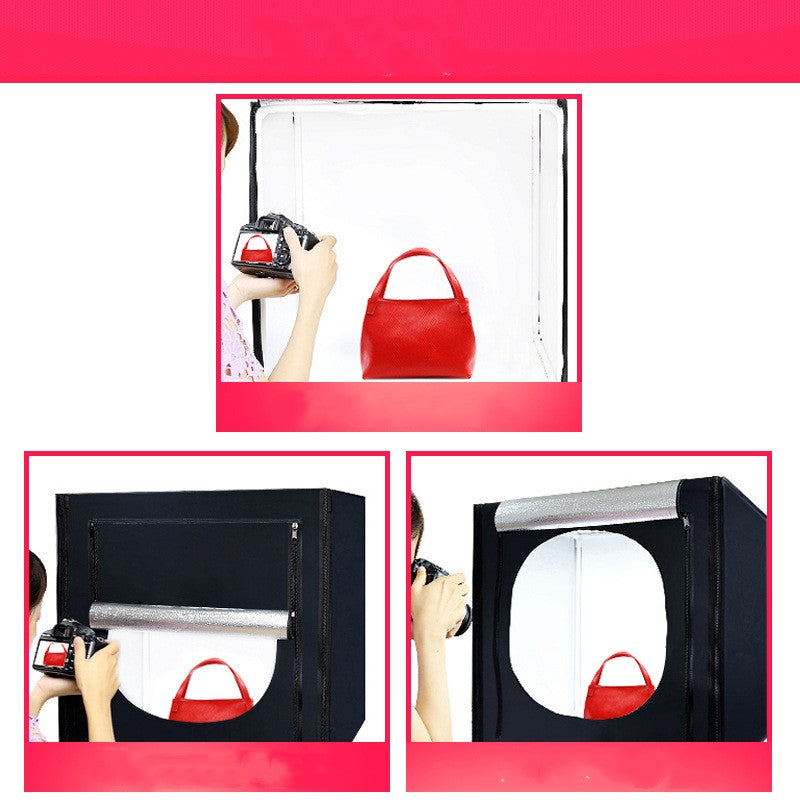 Red handbag being photographed with a softbox light modifier on a white background.