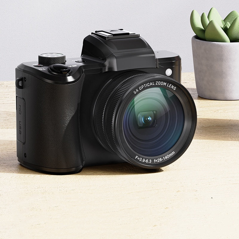 Black camera with large lens on a wooden surface next to a potted plant