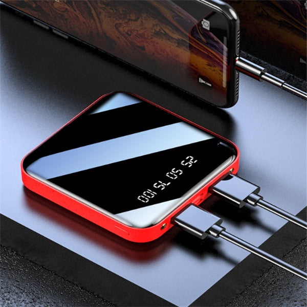 Red power bank with digital display on a dark surface