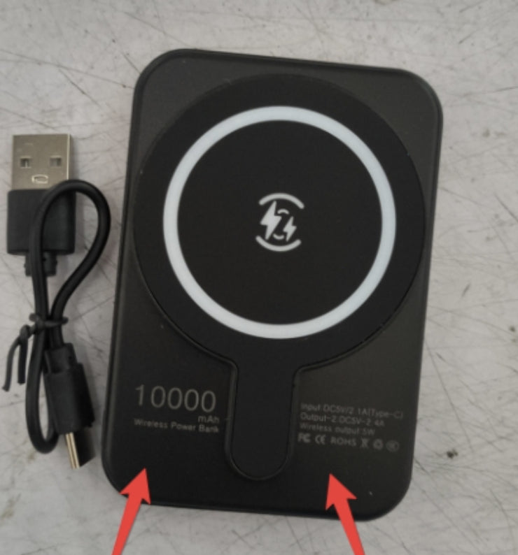 Black wireless power bank with USB cable on a textured surface