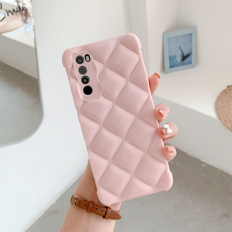 Pink quilted phone case held by a hand with a blurred background