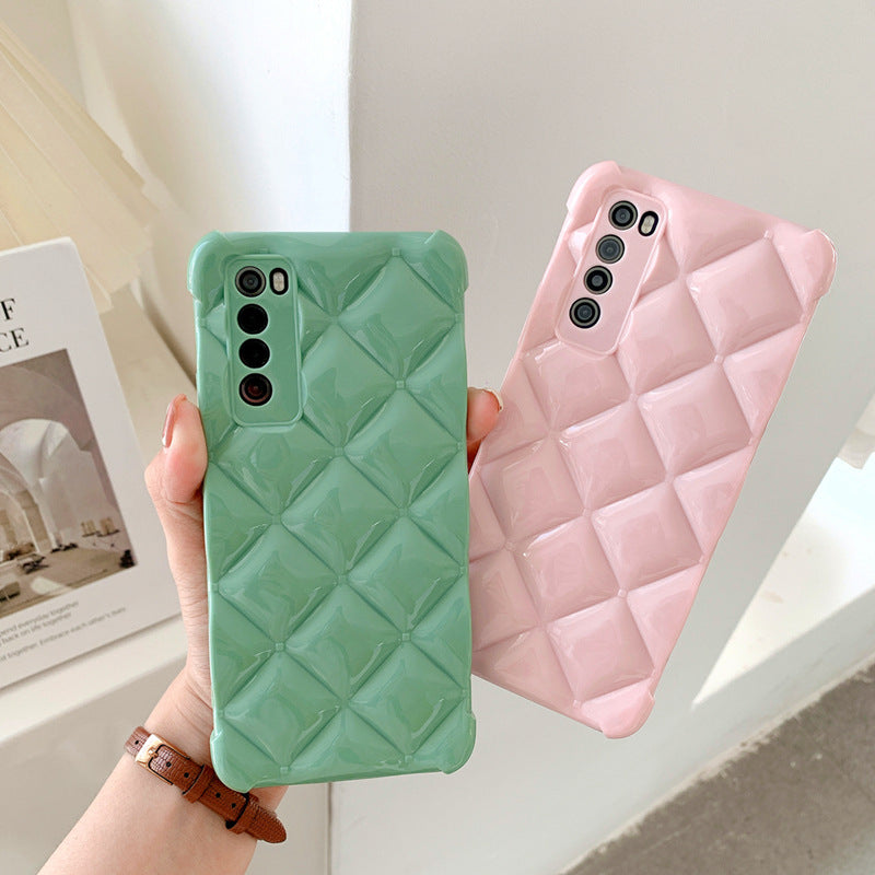 Green and pink quilted phone cases held by a hand with a blurred background