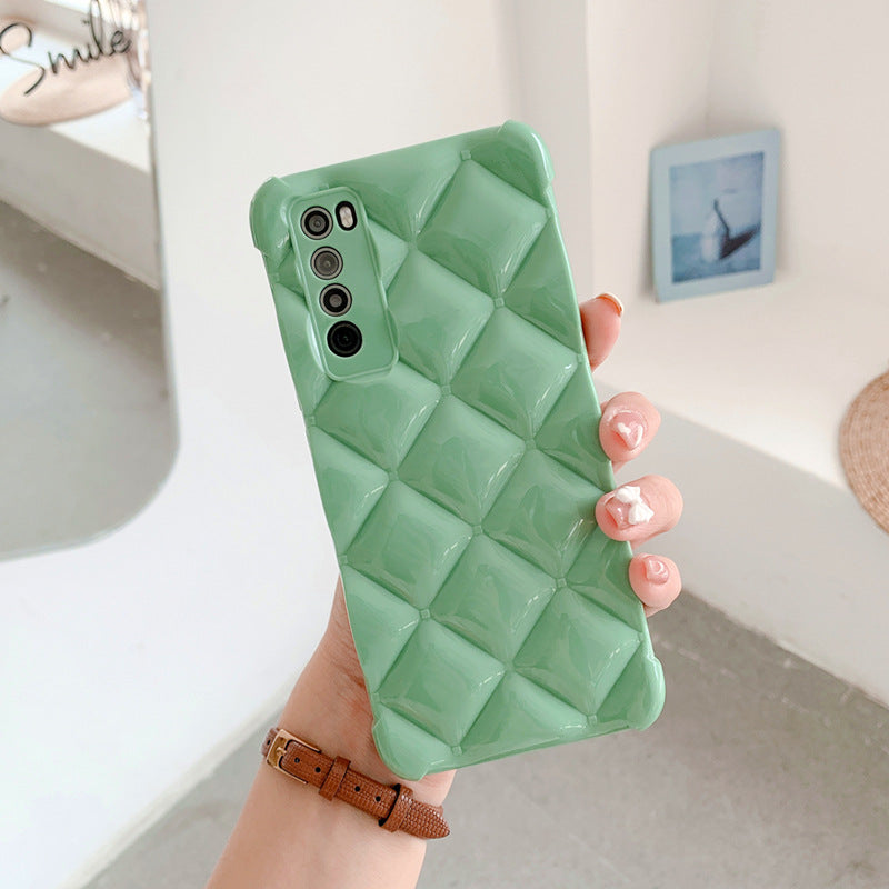 Green textured phone case held by a hand with a blurred background