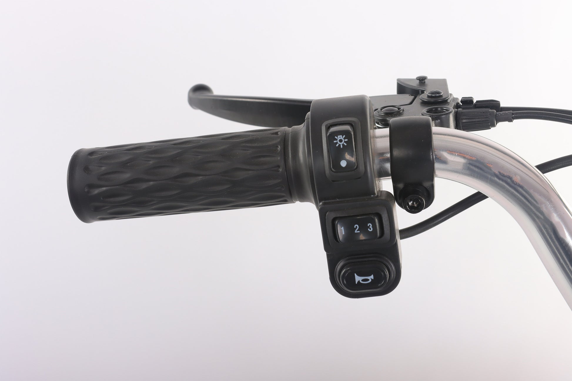 Close-up of a motorcycle handlebar with control buttons on a white background