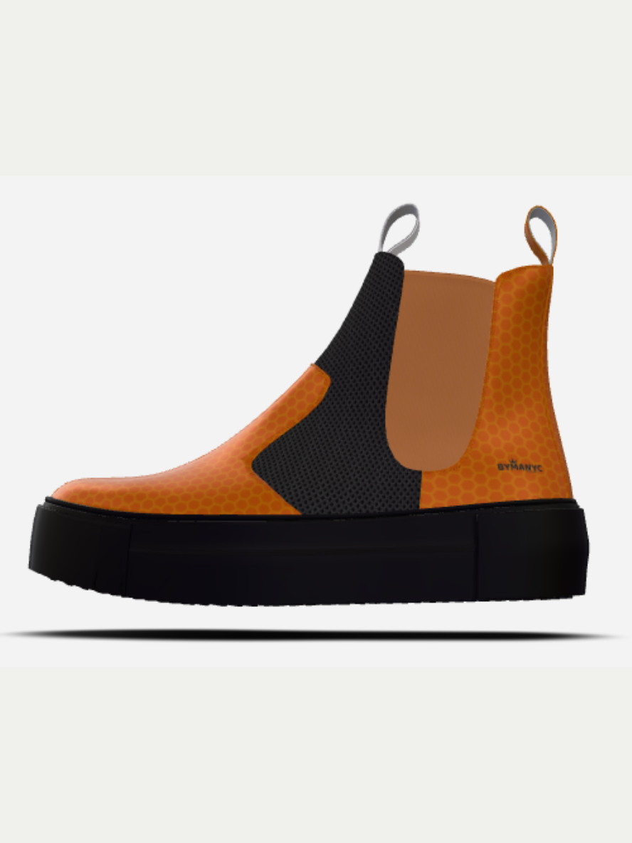 Orange and black Chelsea boot on a white background