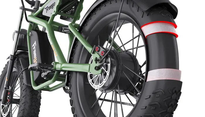 Close-up of a green electric bike with large black tires on a white background