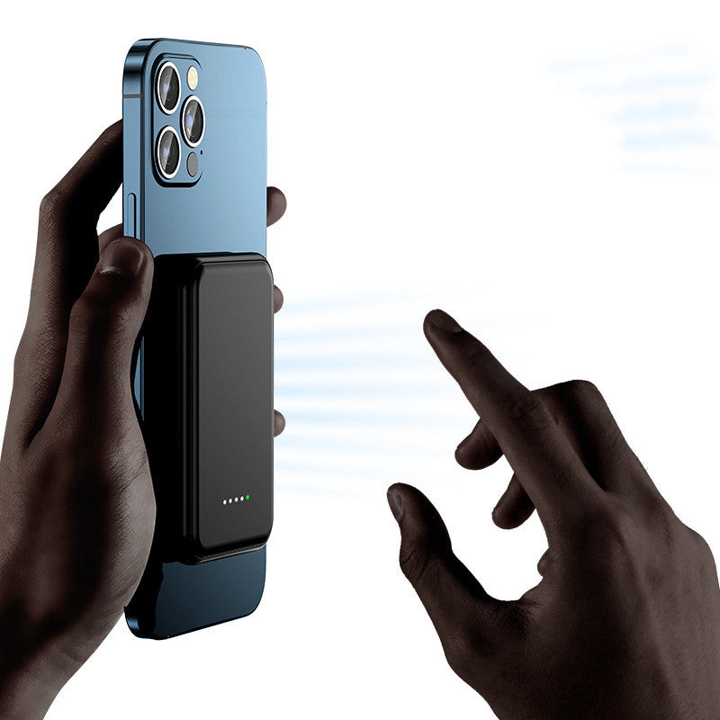 Smartphone with a black magnetic attachment held by two hands on a white background