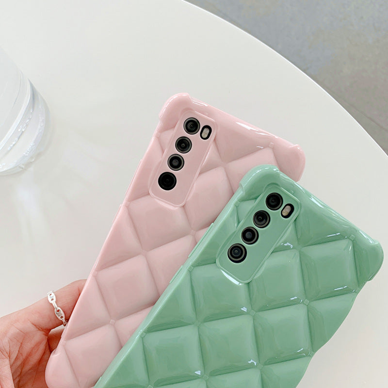 Two phone cases, one pink and one green, with a quilted pattern held by a hand.