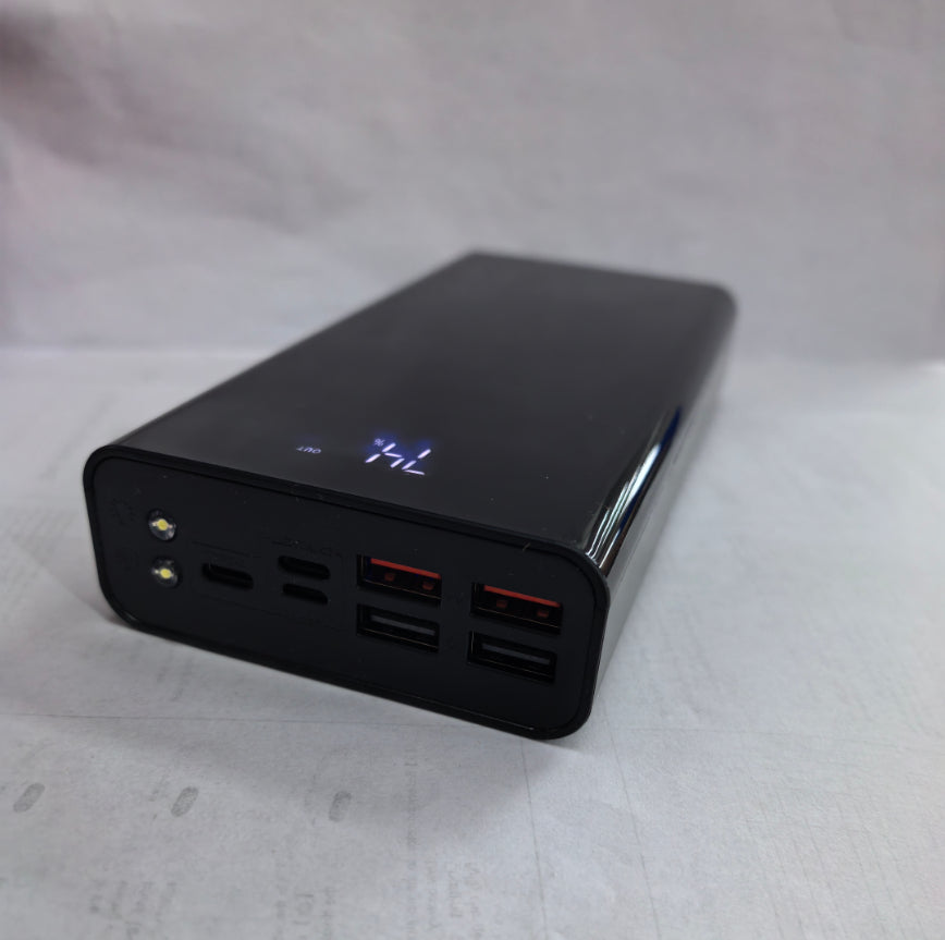 Black power bank with multiple USB ports on a white background