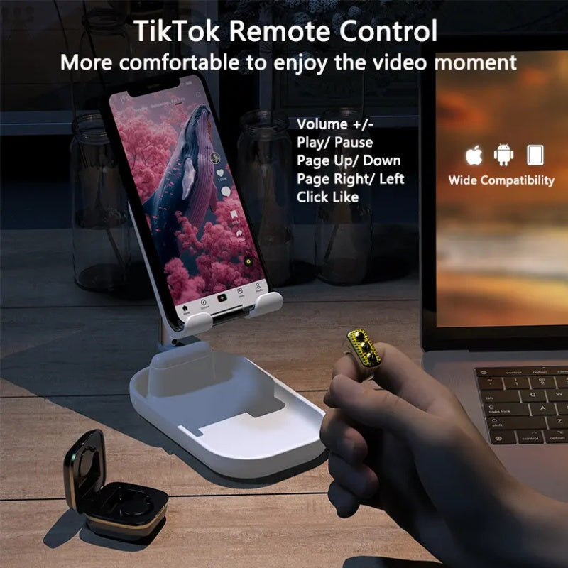 TikTok remote control with smartphone stand and laptop on a wooden table