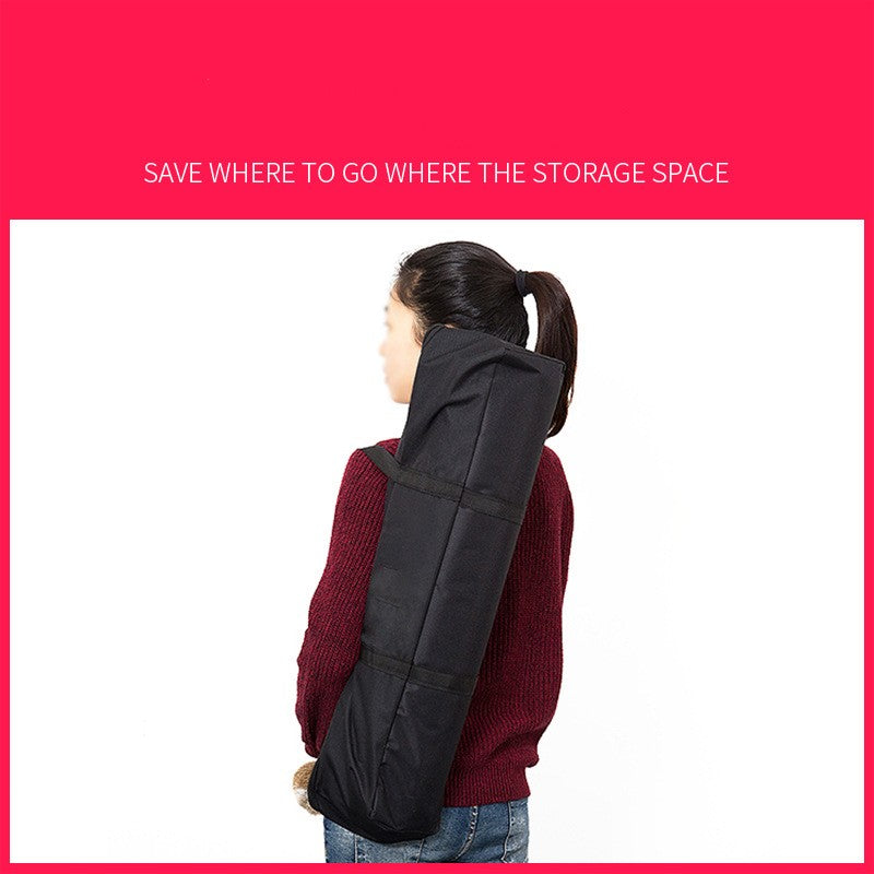 Person wearing a black jacket with storage space on a white background